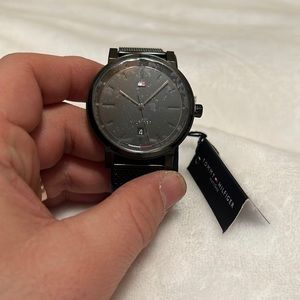 Tommy watch on a black mesh bracelet. New never worn in a box with tags.